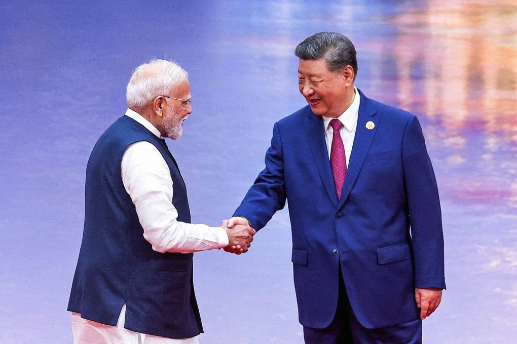 Chinese President Xi Jinping and Indian Prime Minister Narendra Modi (L) shake hands during the welcoming ceremony of the Shanghai Cooperation Organisation summit in Tianjin on August 31. (Photo Indian Press Information Bureau).jpg