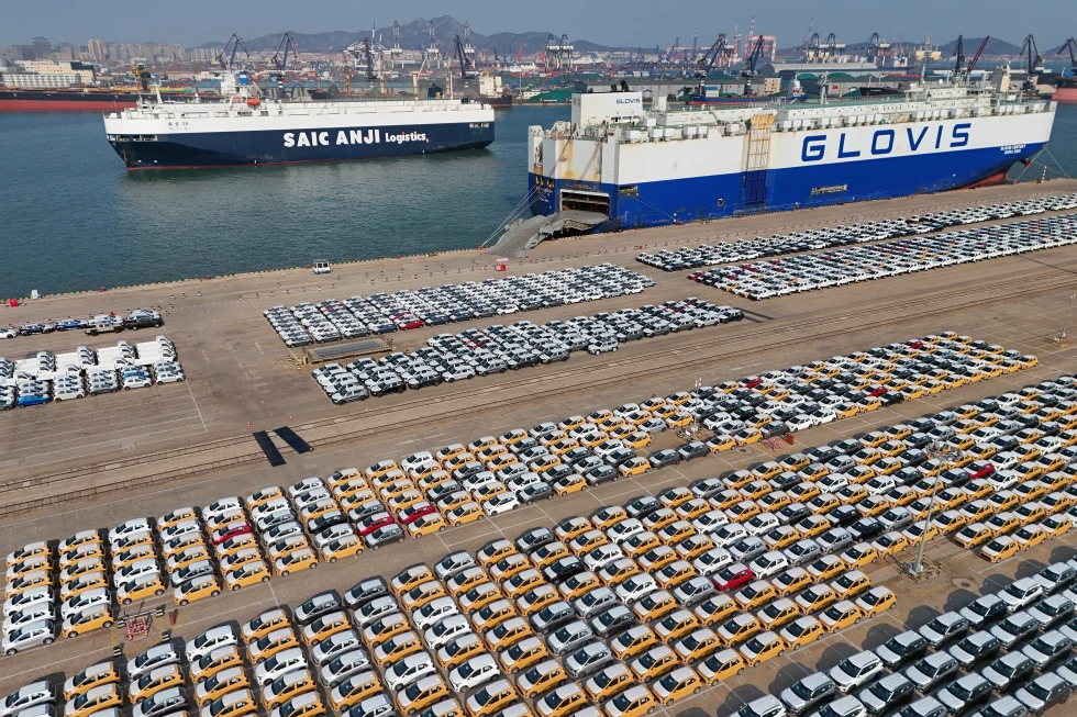 Vehicles and trucks for export wait for transportation from a port in Yantai in eastern China’s Shandong province on Jan. 2, 2025. (AP, File).png