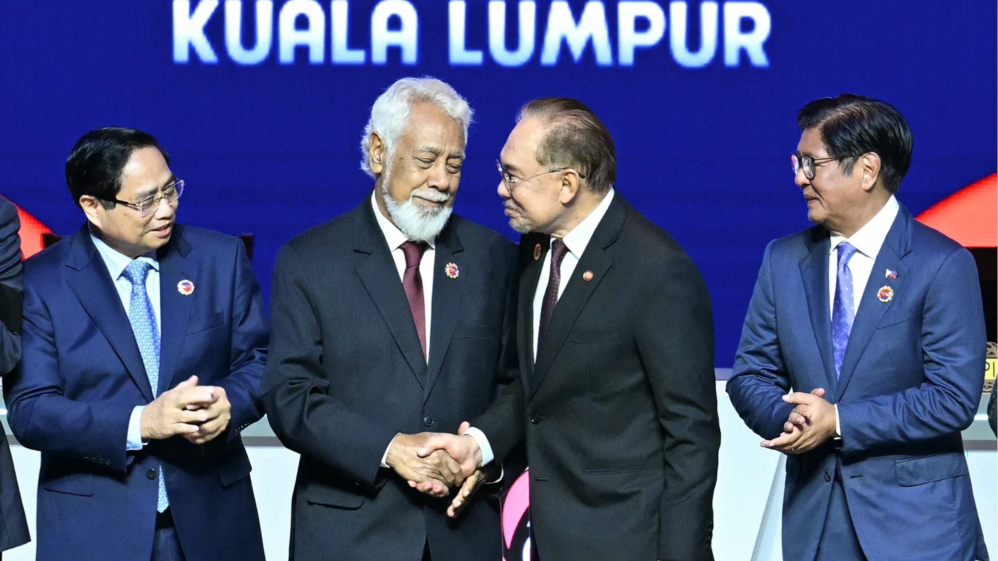 Timor-Leste's Prime Minister Xanana Gusmao (second left) shakes hands with Malaysia's Prime Minister Anwar Ibrahim (second right).png