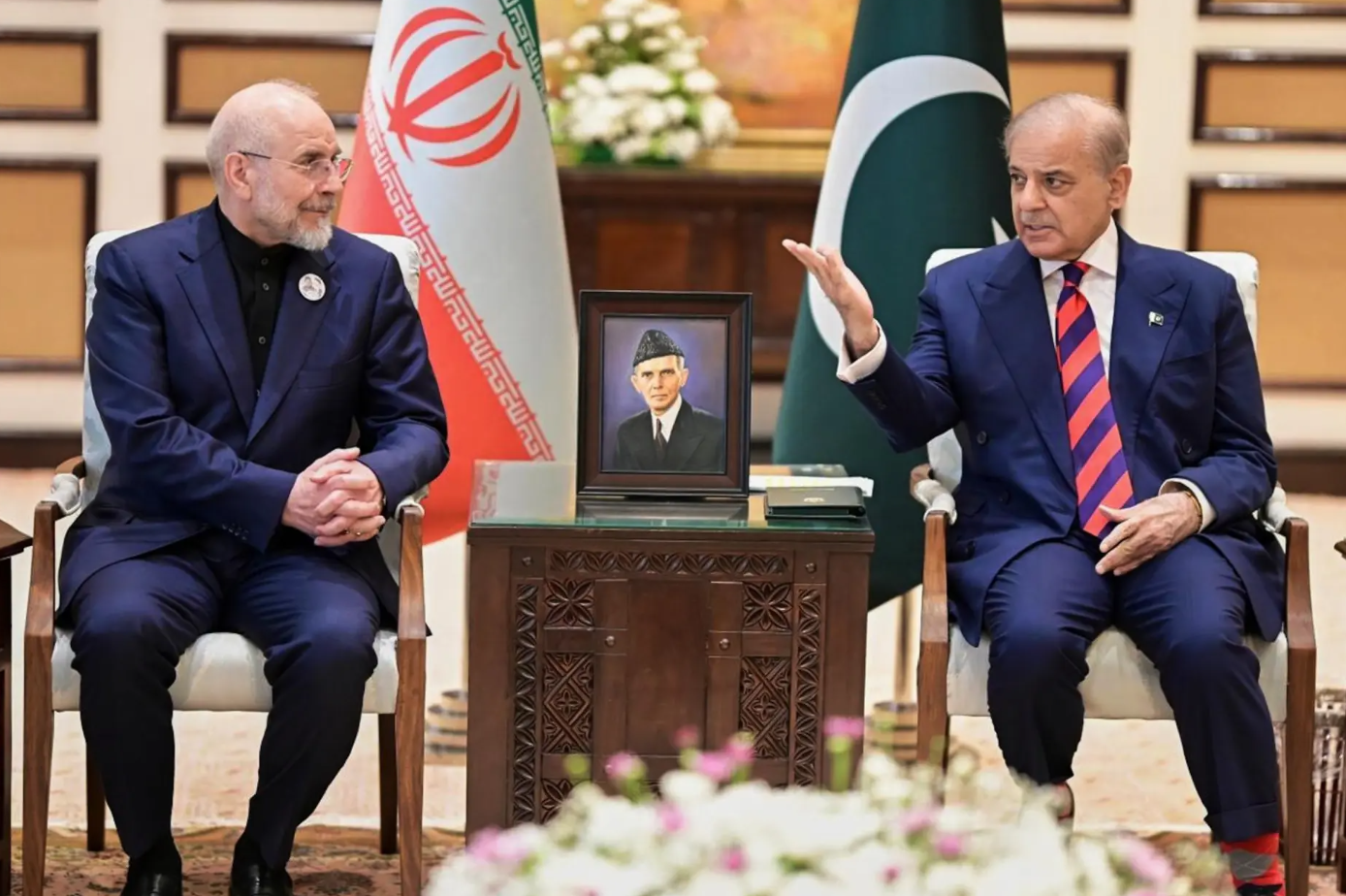 Iran&rsquo;s Parliament Speaker Mohammad Bagher Ghalibaf, left, meets with hand with Pakistani Prime Minister Shehbaz Sharif, in Islamabad, Pakistan, Saturday, April 11, 2026. (Pakistan Prime Minister Office).png